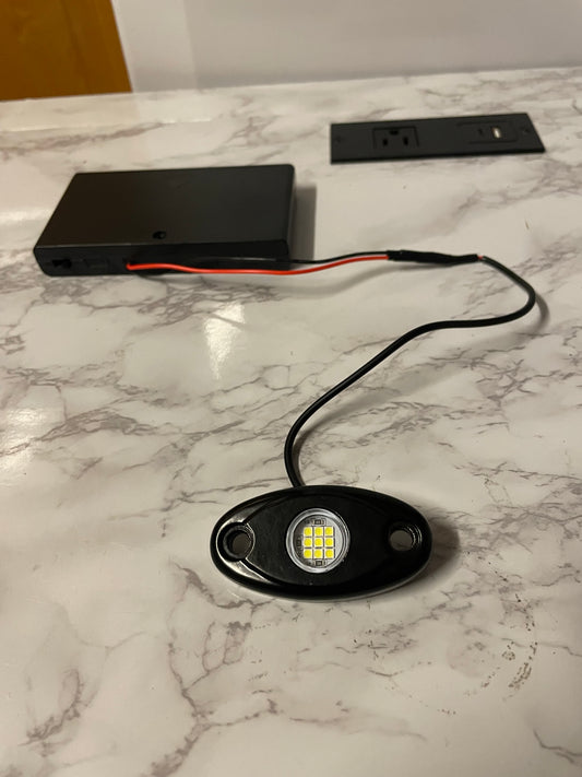 Battery powered rock light with switch